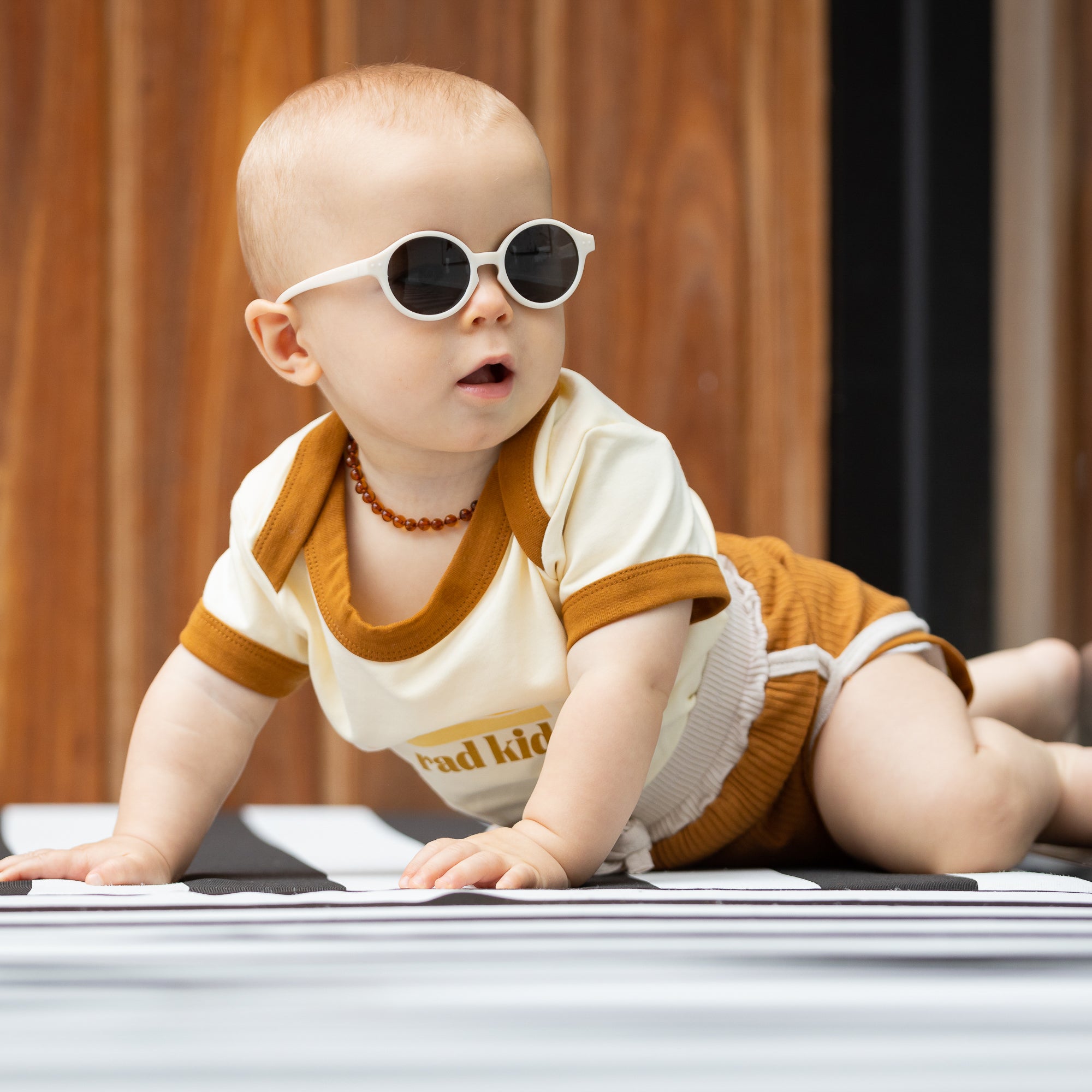 Infant sunglasses with head clearance strap